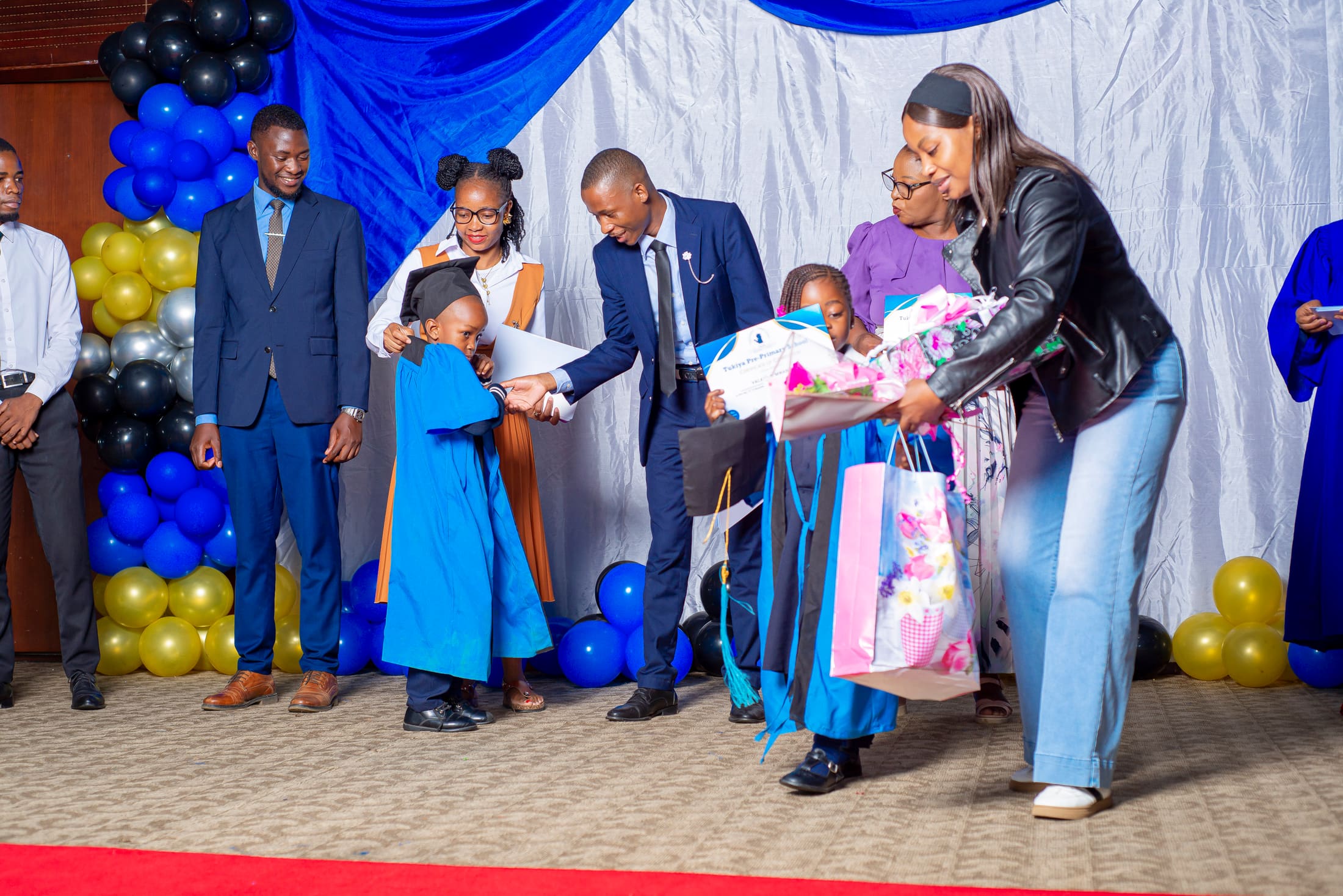 Graduates receiving gifts from staff