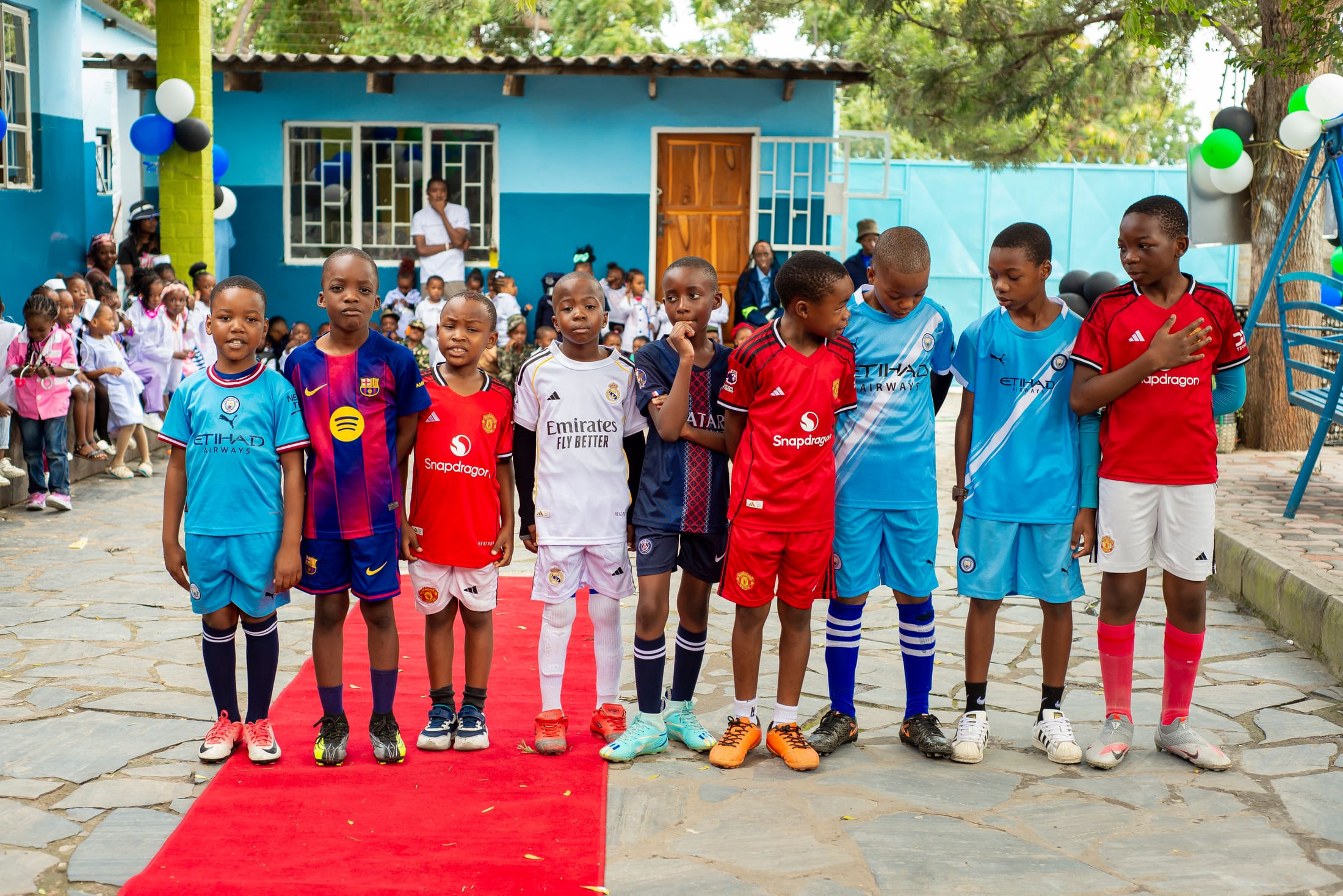 Pupils in football jerseys on the red carpet