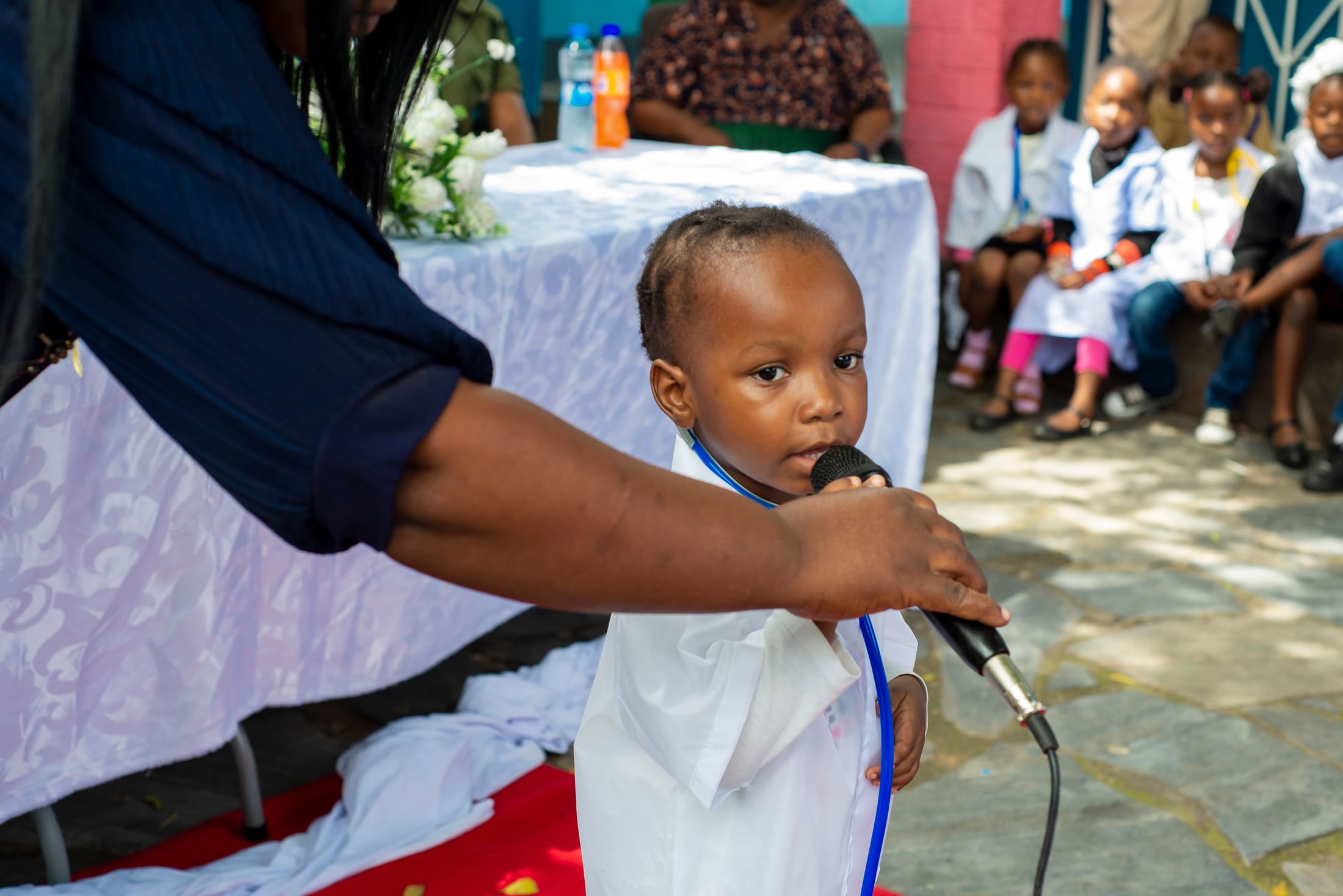 A Tukiya pupil speaking confidently at a school event